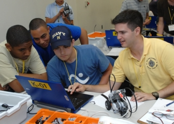 Photo of several students working on an engineering project.